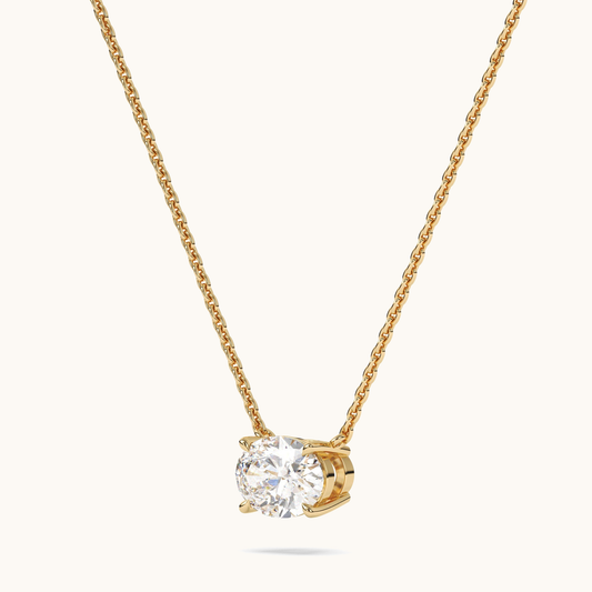 Oval lab-grown diamond pendant on a yellow-gold chain, three-quarter side view