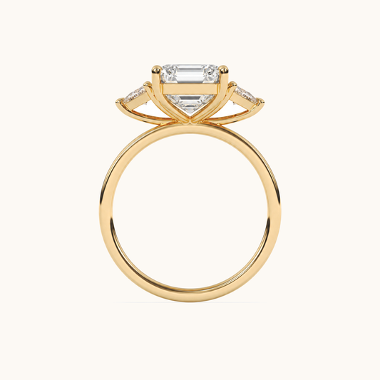 Emerald-cut diamond three-stone ring with trillion diamond shoulders