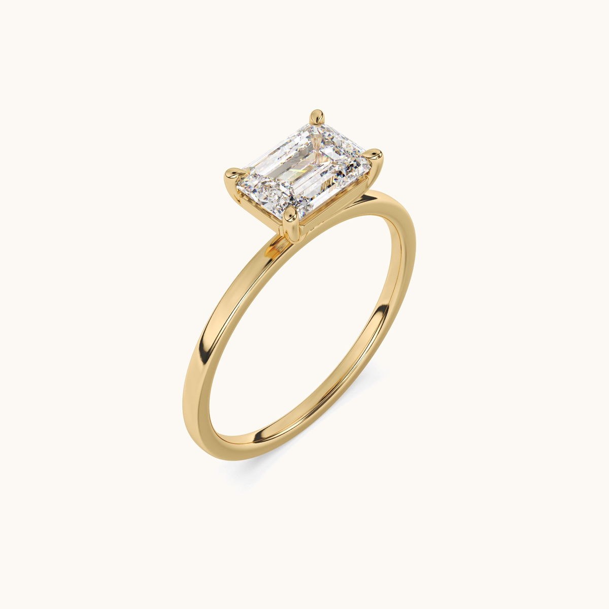 East-to-west emerald-cut lab-grown diamond solitaire ring in yellow gold, angled upright view