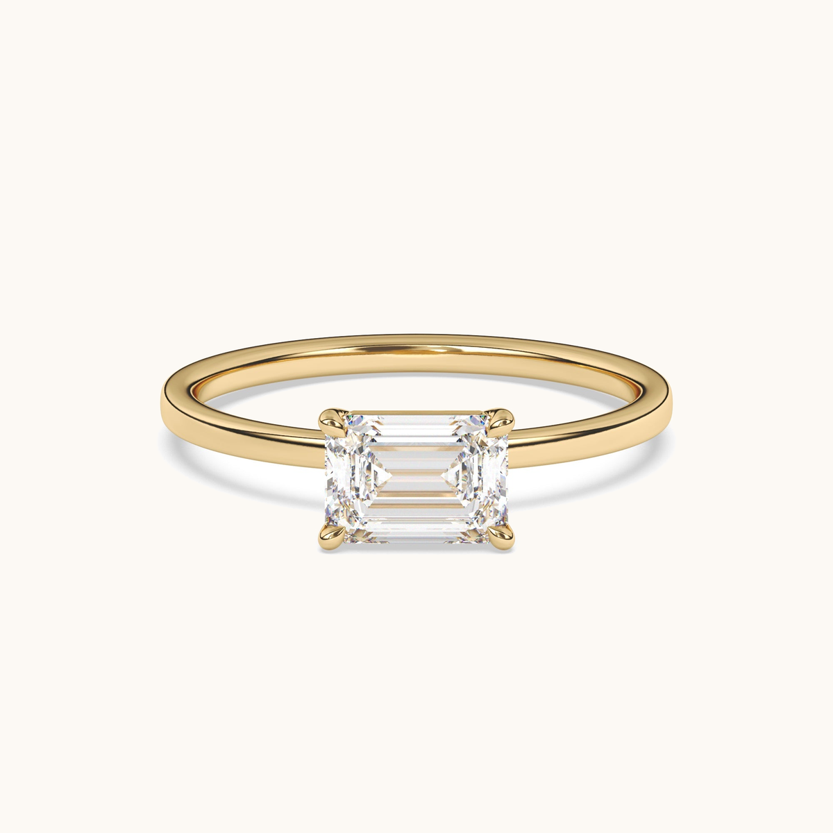 East-to-west emerald-cut lab-grown diamond solitaire ring in yellow gold, low side profile