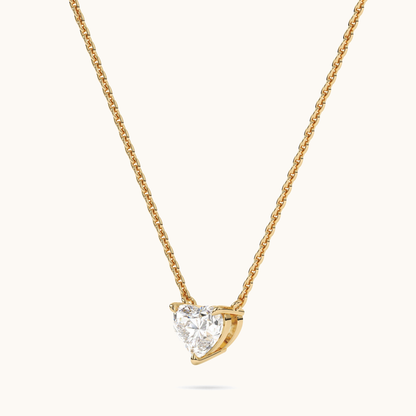 Heart-shaped lab-grown diamond pendant in yellow gold, three-quarter side view