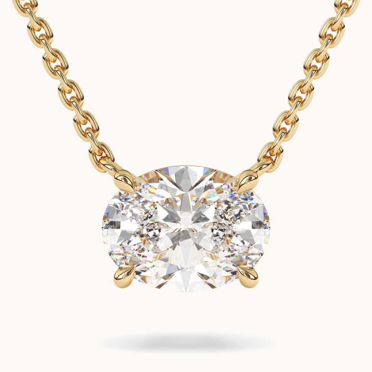Oval lab-grown diamond pendant on a yellow-gold chain, close-up front view