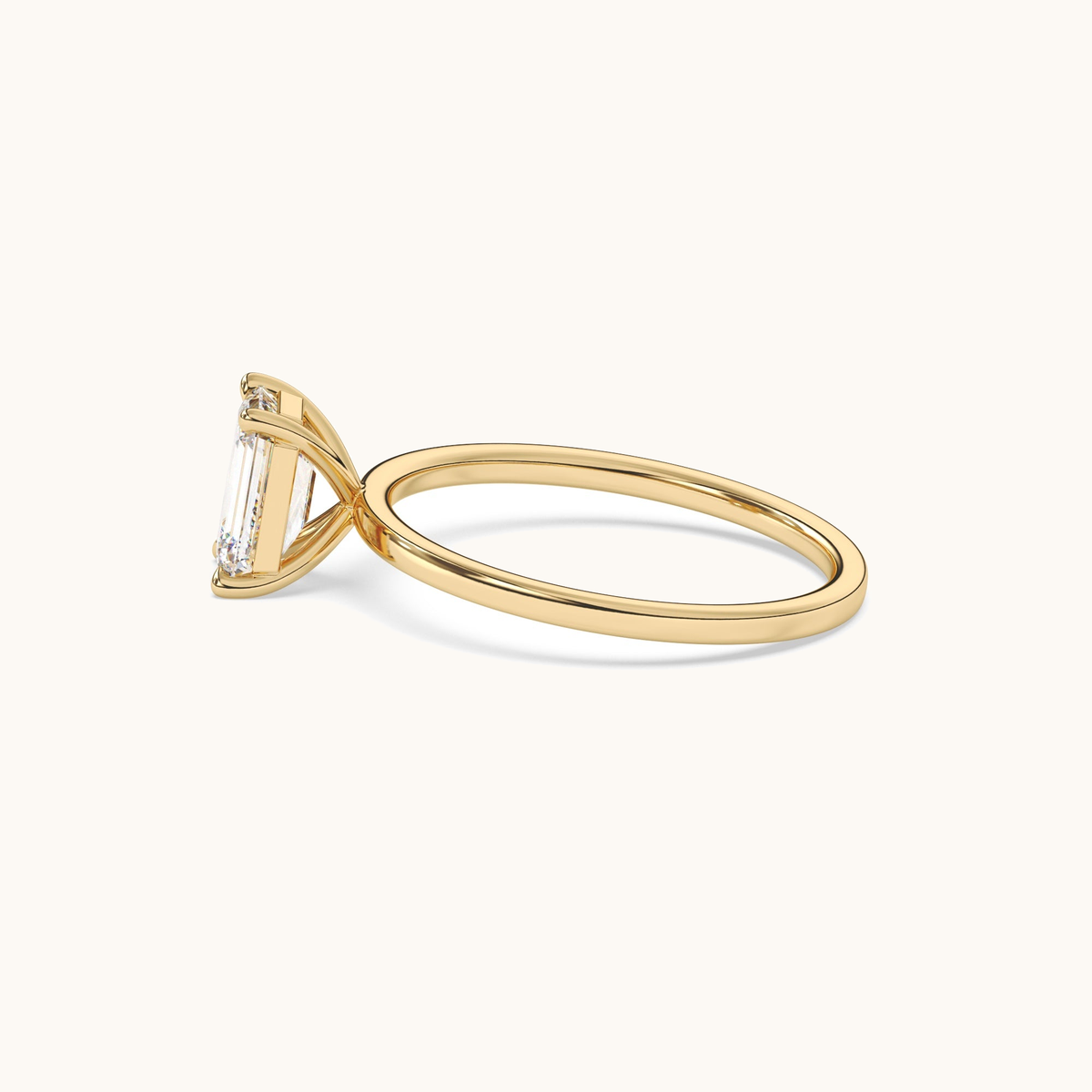 Emerald-cut lab-grown diamond solitaire ring in yellow gold, low front view