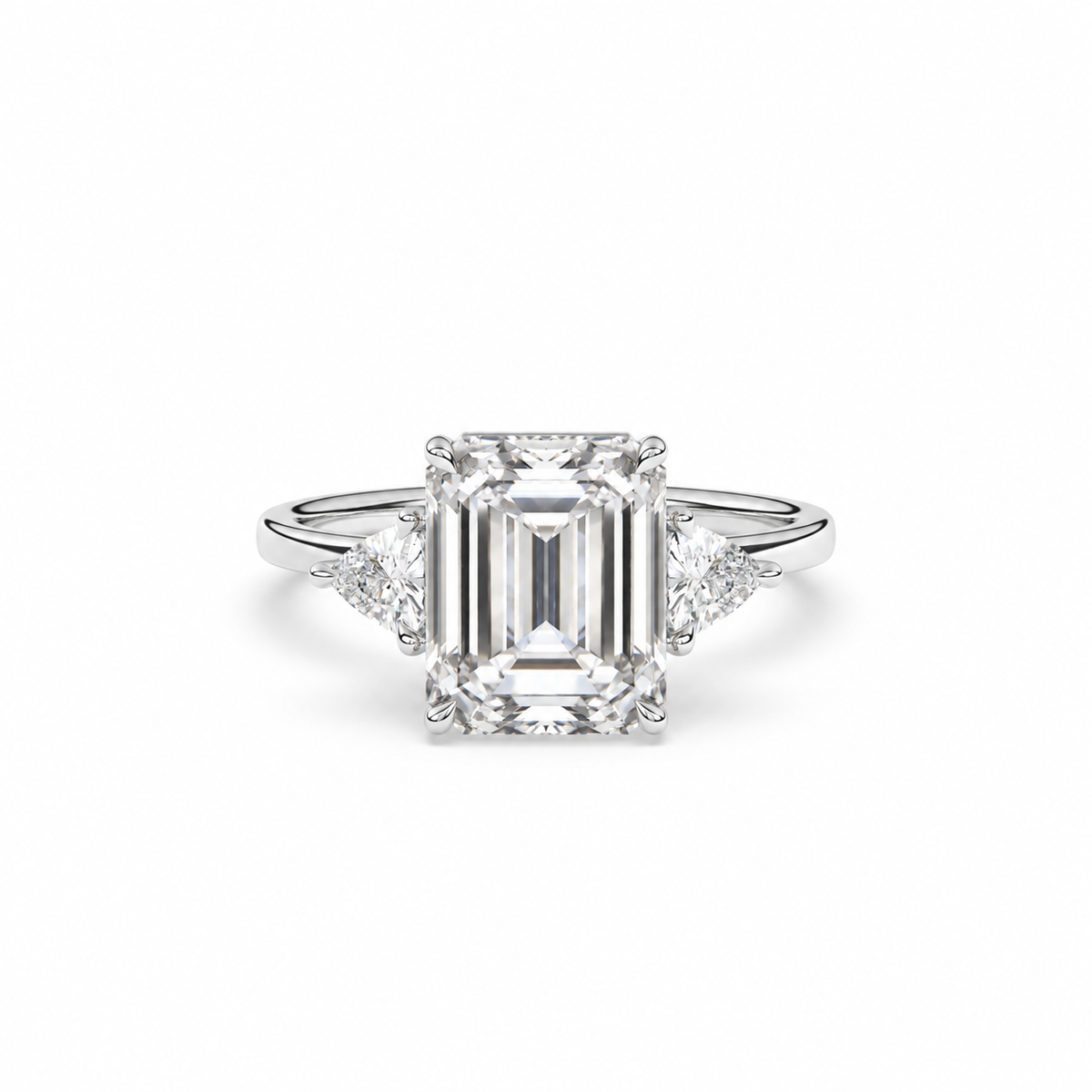 Emerald-cut diamond three-stone ring with trillion diamond shoulders