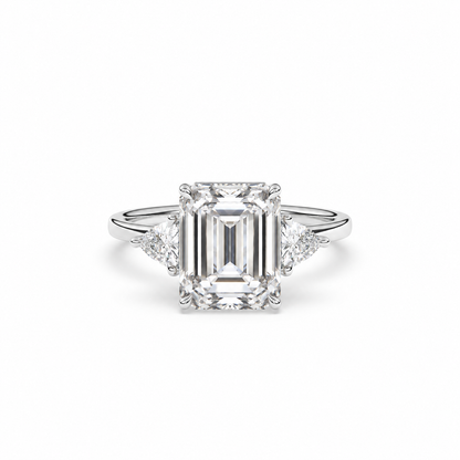 Emerald-cut diamond three-stone ring with trillion diamond shoulders