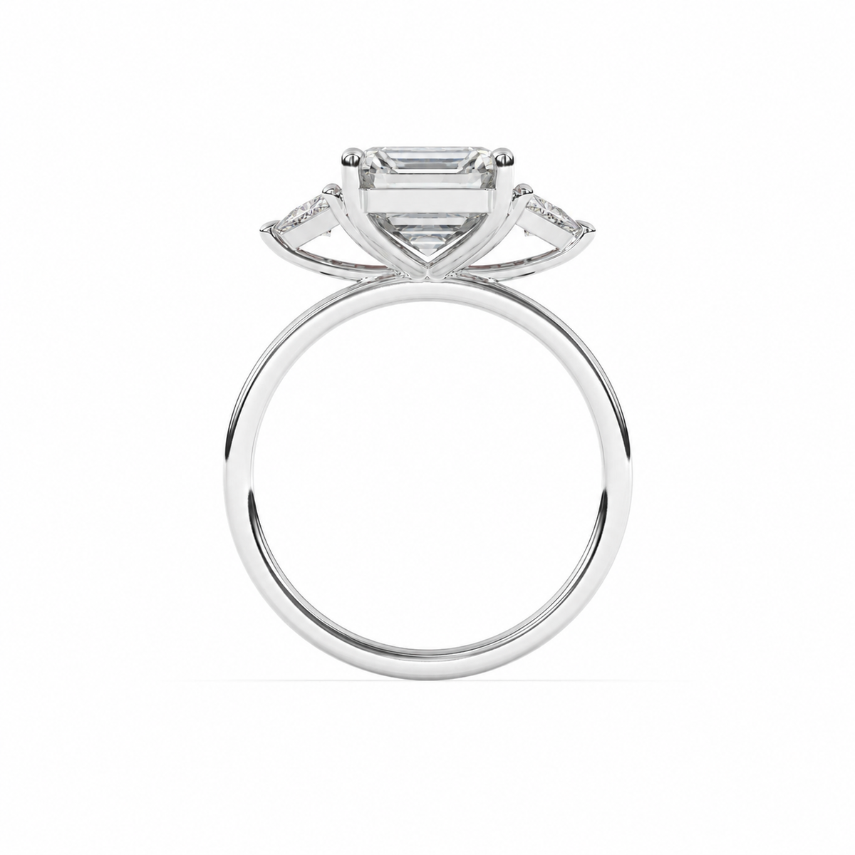Emerald-cut diamond three-stone ring with trillion diamond shoulders