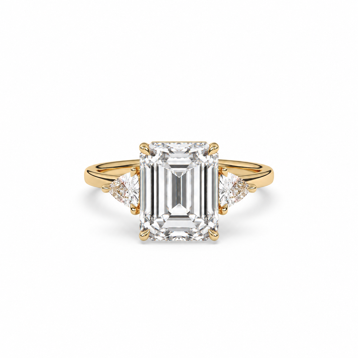 Emerald-cut diamond three-stone ring with trillion diamond shoulders