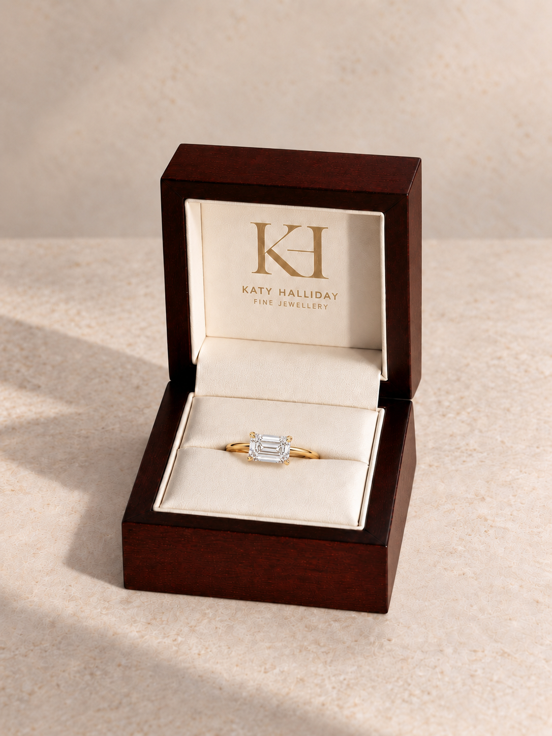 Katy Halliday wooden presentation box with east-west emerald step-cut solitaire