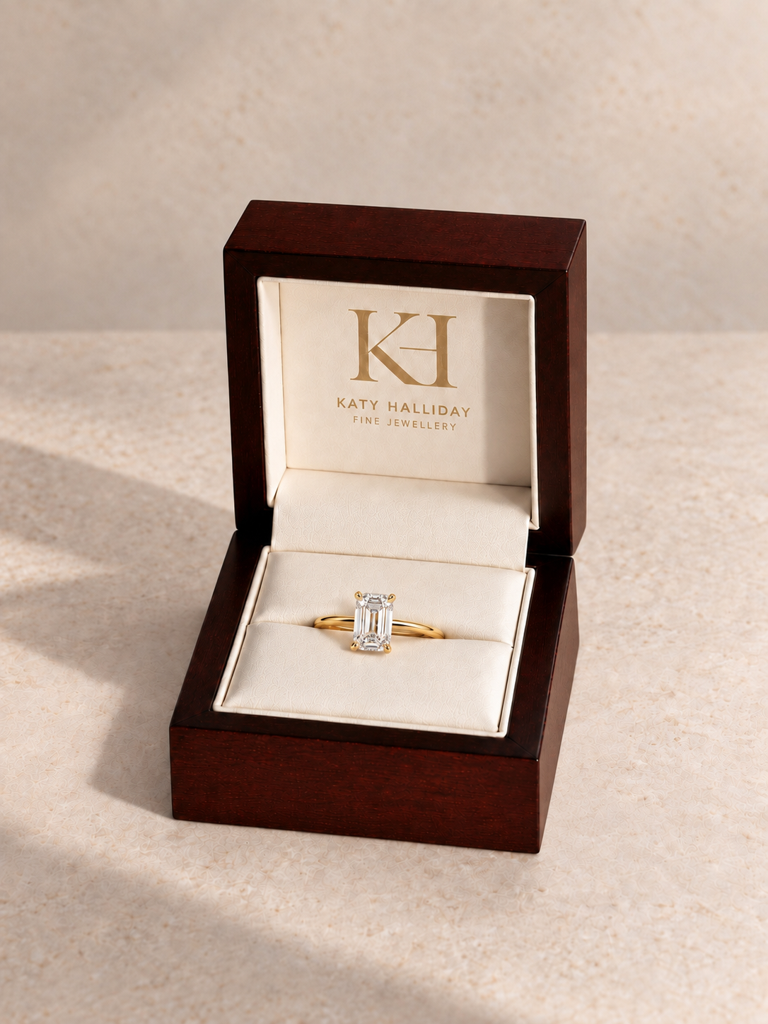 Katy Halliday wooden presentation box with north-south emerald step-cut solitaire