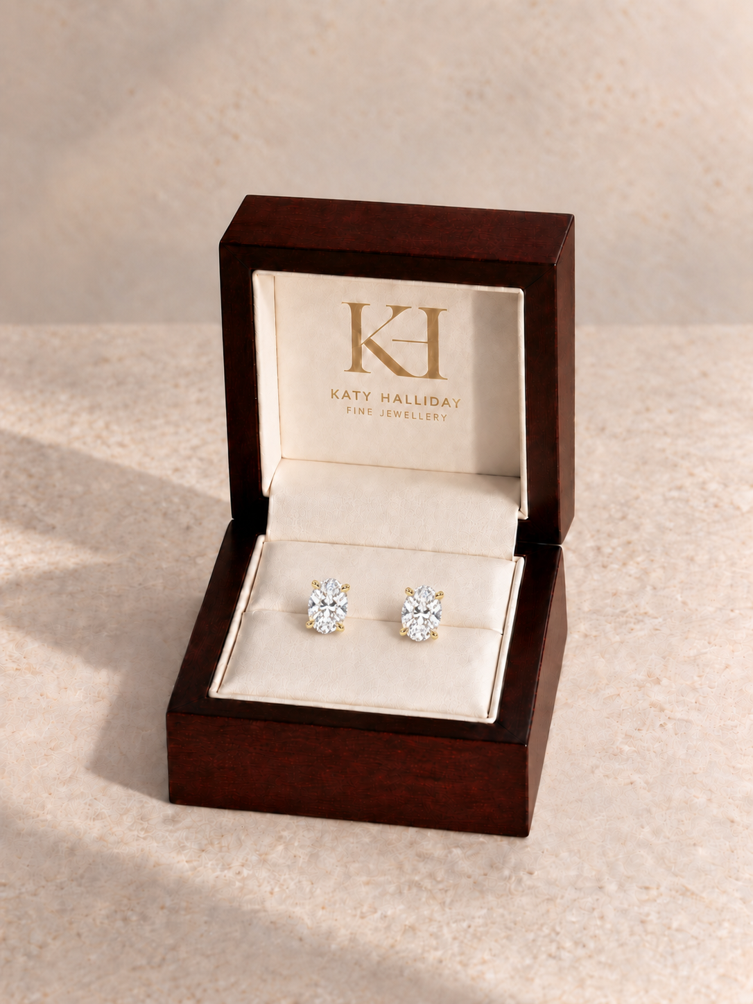 Oval diamond earrings in the Katy Halliday presentation box, yellow gold