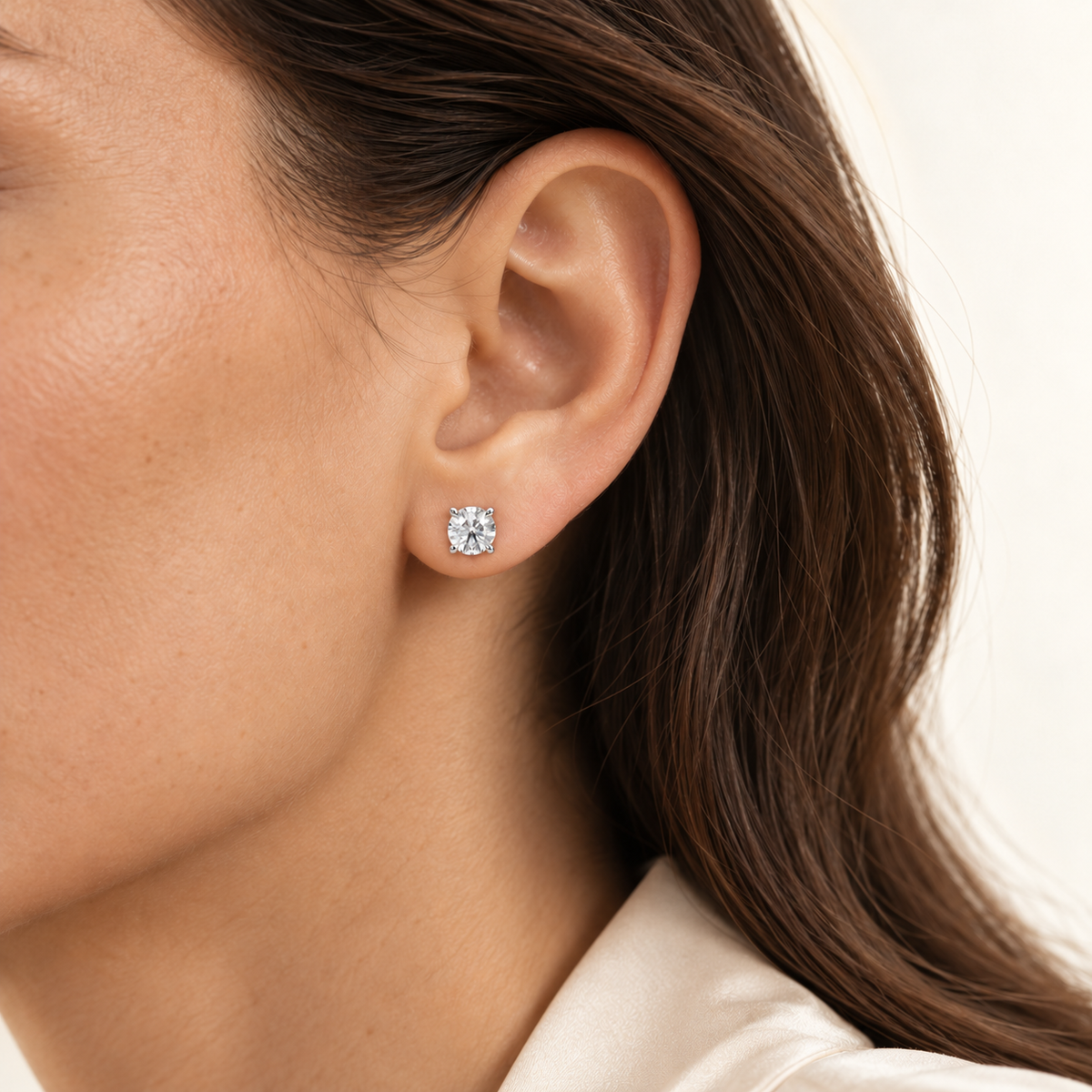 Round brilliant diamond studs, 1.5 ct total, white gold, worn on ear