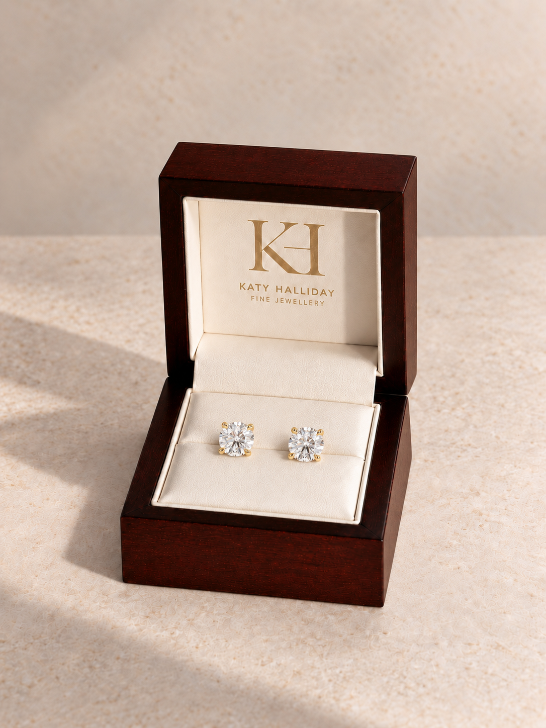 Round brilliant yellow-gold diamond studs in the Katy Halliday wooden presentation box