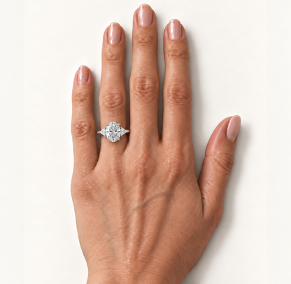 Oval diamond three-stone ring worn on the ring finger in white metal
