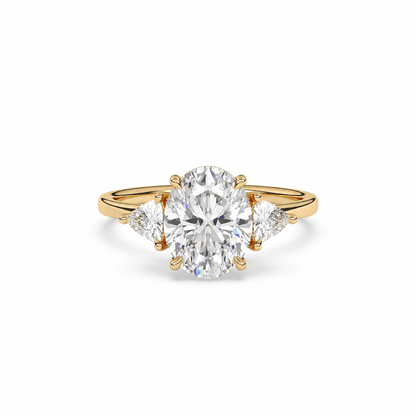 Front view of an oval diamond three-stone ring in yellow gold with trillion diamond shoulders