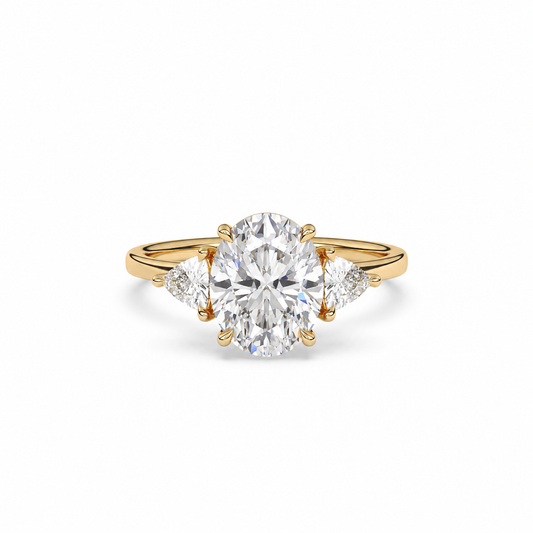 Front view of an oval diamond three-stone ring in yellow gold with trillion diamond shoulders