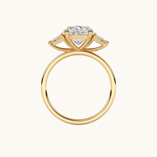 Side gallery view of an oval diamond three-stone ring in yellow gold with trillion diamond shoulders