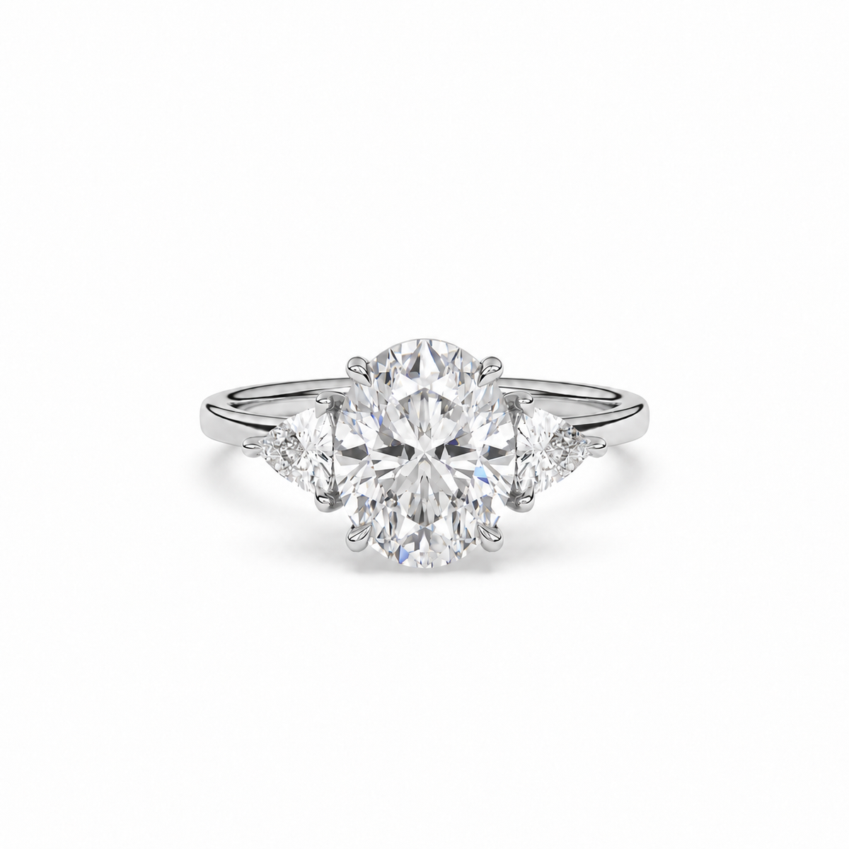 Front view of oval diamond three-stone ring in white metal