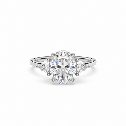 Front view of oval diamond three-stone ring in white metal