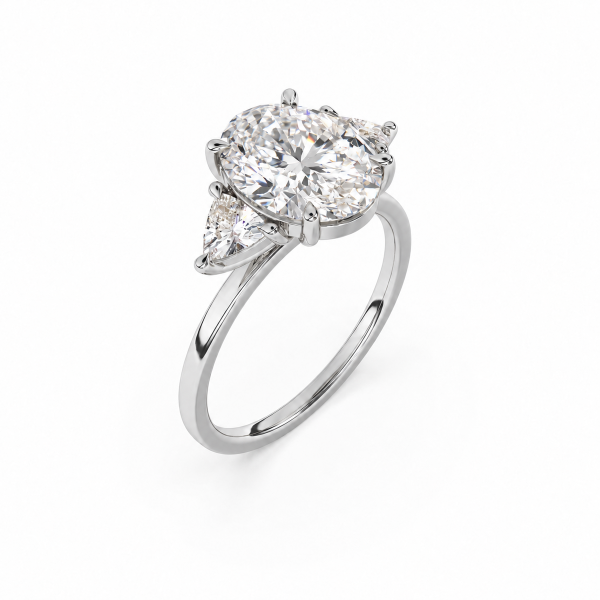 Three-quarter view of oval diamond three-stone ring in white metal