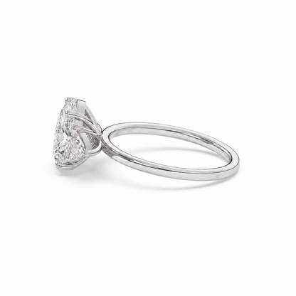 Low side view of oval diamond three-stone ring in white metal