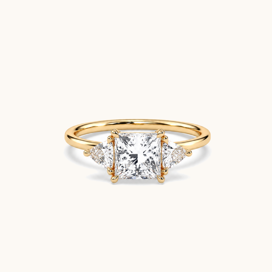 Princess and trillion diamond ring in yellow gold, lying-down view with approved solitaire shank profile